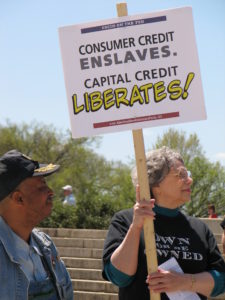 Photo of Barbara Olson holding sign at 2007 Rally at Lincoln Memorial and Federal Reserve