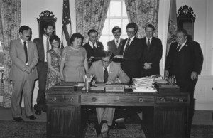 Photo of Delaware Governor Pierre S. duPont signing expanded capital ownership legislation for Delaware citizens.
